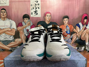 Front view of white basketball shoes with black laces and teal accents
