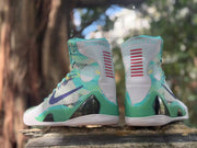 Rear view of the pair showing green heel panels and dark accents