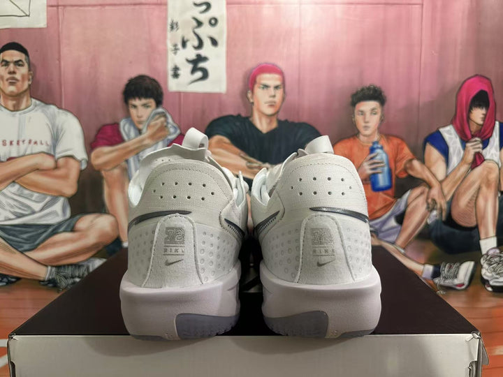 Rear view of white Nike basketball shoes with perforated heels and gray-blue outsole accents