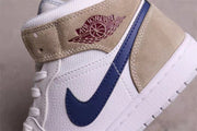 Close-up of the dark blue side Swoosh, tan ankle overlay, and winged basketball collar branding.