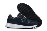 Navy sneakers shown from the side and outsole, highlighting the tread pattern.