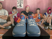 Front view of the blue textured toes, white laces, coral tongue details, and translucent blue outsoles.