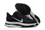 Black Nike Pegasus shoes shown from the side and outsole, highlighting the white midsole and patterned tread.