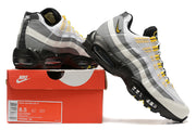 Nike Air Max 95 TT sneakers in white, grey, black, and yellow displayed with a shoe box labeled size 8.5 and DQ3982 100.