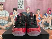 Front view of red and black high-top sneakers with black laces, translucent toe sections, and Nike branding.