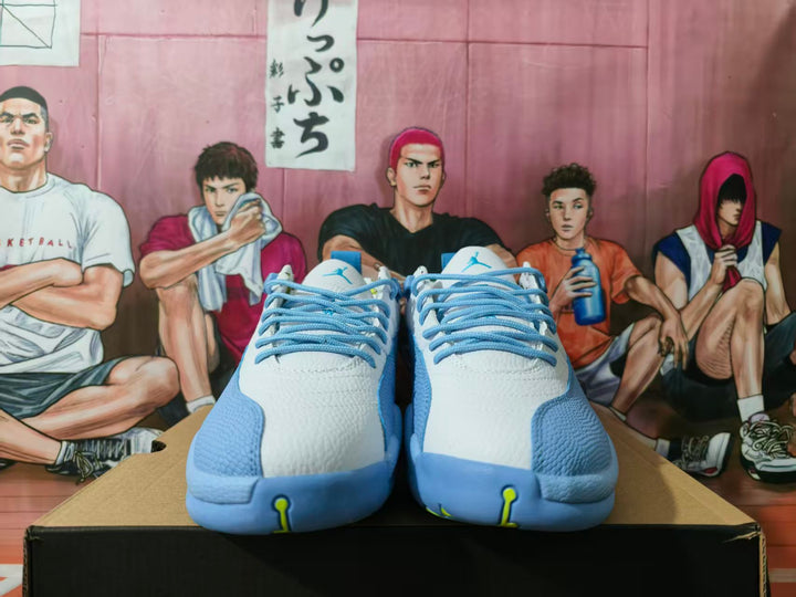 Front view of white and blue Jordan sneakers with blue laces and Jumpman tongue logos displayed on a box.