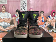 Front view showing the multicolor woven toe panels, black laces, bright green tongue emblems, and light-colored outsoles.