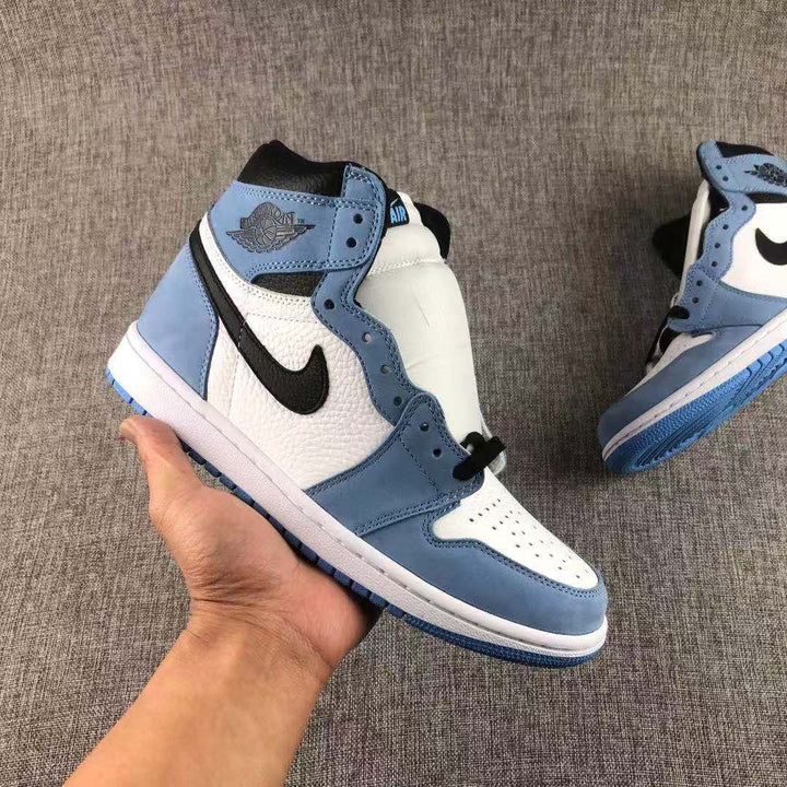 Close-up of a University Blue, white, and black high-top sneaker showing the side Swoosh and padded collar.