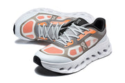 Pair of gray and orange On Cloudswift Remix shoes shown at an angled view.