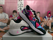 Pair of white Jordan basketball sneakers showing the multicolor patterned upper panels, black trim, and white midsoles.