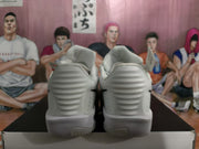 Rear view showing the padded heel sections, layered heel detailing, and textured outsole edges of the white sneakers.