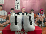Rear view of white and black Nike high-top sneakers showing “THE GLOVE” rear pull tabs.