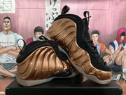 Angled view of the pair showing the sculpted bronze upper, black overlays, laces, and translucent outsole.