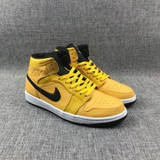 Pair of yellow and black mid-top sneakers shown from the front three-quarter angle.
