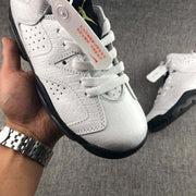 Close-up of the white textured toe box, laces, perforations, and attached tag.