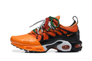 Side view of an orange and black Nike Air Max Plus sneaker with multicolor laces.