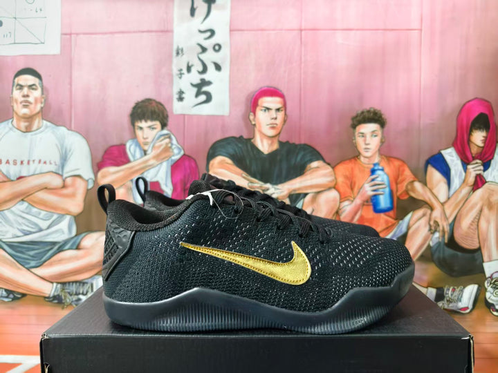 Side view of black Nike basketball shoes with gold Swoosh detailing