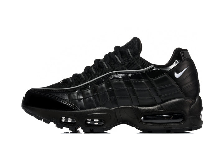Black Nike Air Max 95-style sneaker with layered side panels, mesh upper, white Swoosh, and visible air units