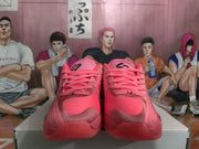 Front view of pink Jordan basketball sneakers showing laces, padded tongues, textured toe areas, and black tongue branding.