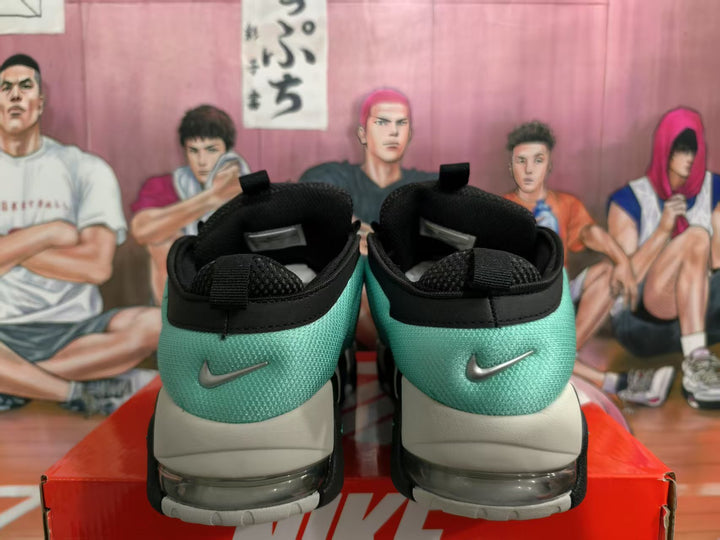 Rear view of black and green Nike sneakers showing the heel branding and transparent cushioning units.