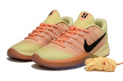 Pair of yellow and orange Nike Sabrina 3 shoes with black side details