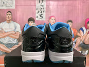 Rear view showing the black heel panels, blue collar lining, white midsoles, and translucent blue outsole sections.
