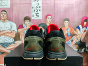 Rear view of black camouflage basketball sneakers showing red inner collars, olive-toned heel sections, and cream-colored outsole edges.