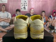Rear view showing cream-colored heels, yellow translucent heel sections, speckled midsoles, and the numbers 8 and 24.