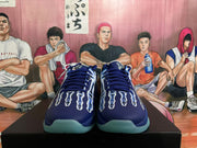 Front view of blue Nike basketball shoes with patterned uppers and turquoise outsoles