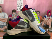 Angled view showing the dotted Swoosh, perforated side panels, red heel sections, purple collars, and Nike Zoom midsole branding.