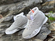 Angled view highlighting the laces, tongue emblem, and textured overlays