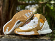 Side and outsole view showing segmented tread and gold detailing