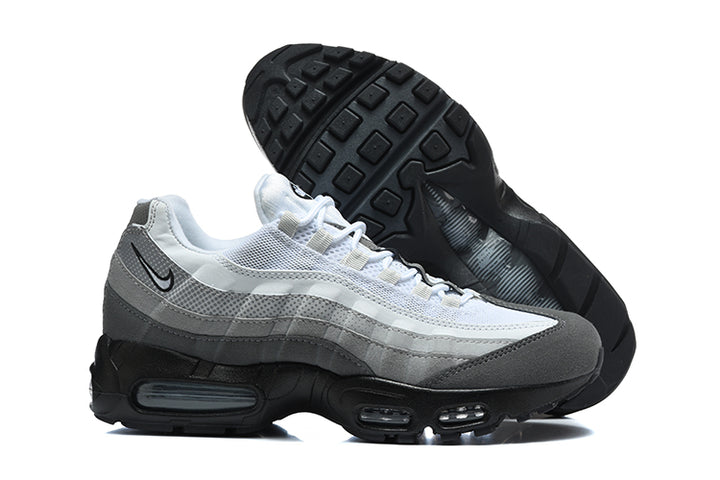 Side view of grey and white Nike Air Max 95 TT sneakers with black soles