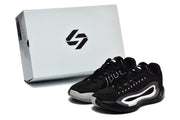 Pair of black and white sneakers displayed beside a branded shoebox.