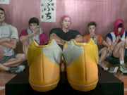 Rear view showing yellow heel sections, white contrasting panels, and visible Converse branding.