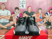 Front view of the Nike sneakers showing black laces, gray toe panels, fluorescent green details, and white midsoles.