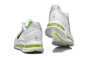 Rear and outsole views of Nike Pegasus Premium shoes with white, gray, and volt details.