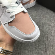 Close-up of the rose-gold toe panel, white leather edge, and white laces.