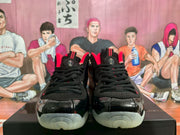 Front view showing black laces, red accents, glossy toe panels, and translucent outsoles.