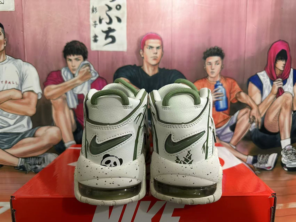 Rear view of off-white Nike sneakers with dark green accents, panda graphics, and speckled soles.