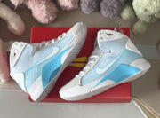 Angled overhead view of Nike HD2008 kids high-top sneakers showing side panels and outsole edges.