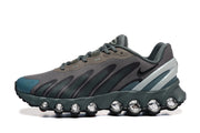 Side profile of a grey and teal Nike Air Max DN8 sneaker with a sculpted sole and rounded visible elements.