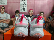 Rear view of white Nike basketball shoes with bright pink heel loops and pale pink outsole details