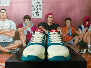 Front view showing the perforated toes and laces of blue and white Nike shoes