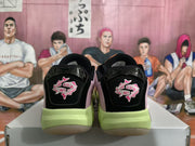 Rear view of the pair showing black heel panels, embroidered pink-and-white graphics and lime midsoles.