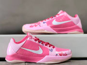 Three-quarter view of a pink Kobe 5 shoe with heart graphics