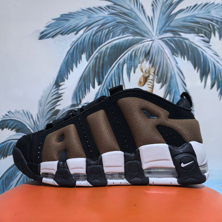 Side view of brown and black Nike sneakers with layered panels, a visible Swoosh, and a segmented sole.
