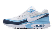 Side profile of a Nike Air Max sneaker showing its white, light blue and navy details.