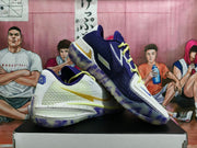 Angled side view showing the mesh-textured upper, gold swoosh detail, layered white midsole, and translucent purple outsole.