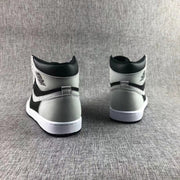 Rear view showing the black and grey heel panels and white midsoles.